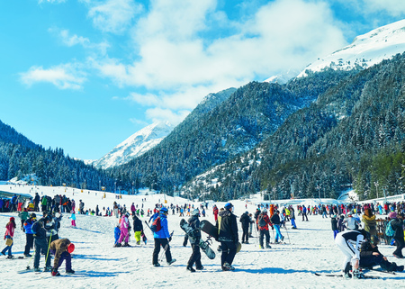 Bansko, Bulgaria - Circa February 2017: Mountain. Skiers climbing on the piste. Ski resort. Ski track. People ski on snow in the winter. Pine forestのeditorial素材