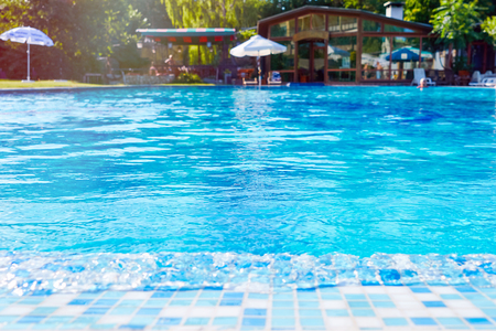 Swimming pool with fresh mineral water in a luxury resort hotel ski. Bright abstract background ideal for any designの写真素材