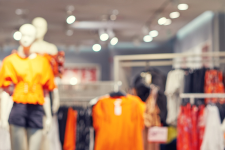 Blurred big sales on Black Friday. On sale at a clothing store in a modern shopping mall. Beautifully laid out things on hangers. Basic background for designの写真素材