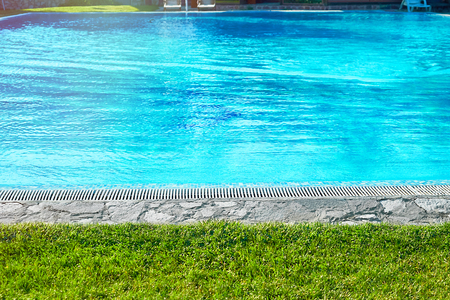 Swimming pool with fresh mineral water in a luxury resort hotel ski. Bright abstract background ideal for any designの写真素材