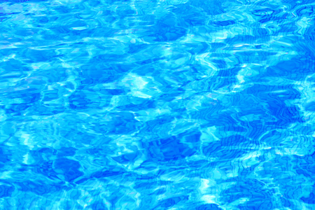 Pattern bottom of the pool of sunlight with fresh mineral water in a luxury resort ski hotel at sunrise. Bright abstract background ideal for any designの写真素材