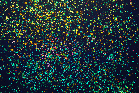 Glitter background. Christmas texture for your design and text. Multicolored sweets on a dark backgroundの写真素材