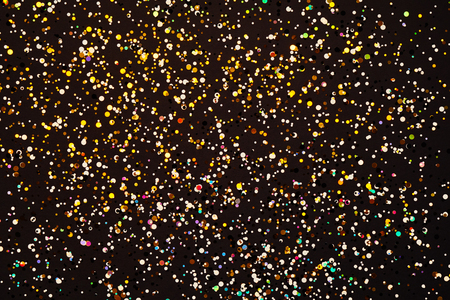 Glitter background. Christmas texture for your design and text. Multicolored sweets on a dark backgroundの写真素材