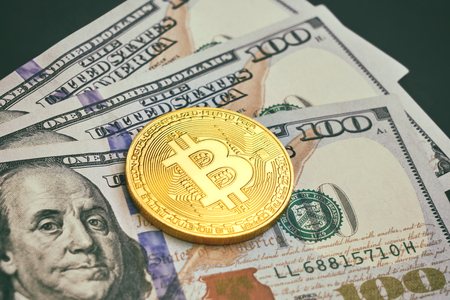 Beautifully arranged bills 100 dollar and gold coin bitcoin on a gray background. Bitcoin cryptocurrency. Anonymous. Background for your text and designの写真素材