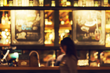 Blurred restaurant or cafe background. Tables and chairs in the lobby of the mall. Visitors to the...