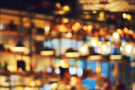 Blurred beautiful design of the ceiling in the restaurant. Bright interior and lights. Blurred bokeh basic background for designの写真素材