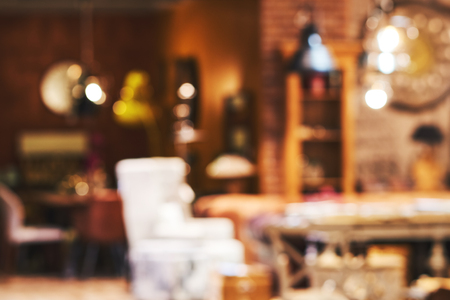 Blurred restaurantl tables and chairs in the lobby of the mall. Visitors to the restaurant for dinner. Beautiful bright interior. Blurred bokeh basic background for designの写真素材