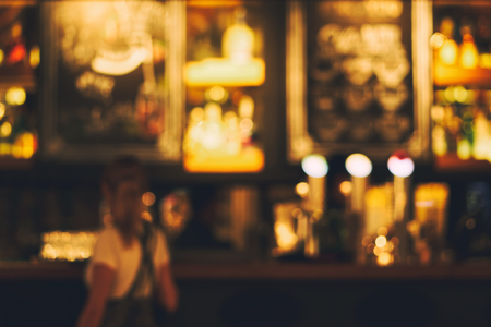 Blurred restaurant or cafe background. Tables and chairs in the lobby of the mall. Visitors to the...