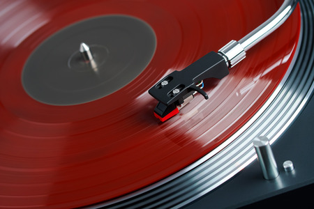 Turntable vinyl record player. Sound technology for DJ to mix & play music. Needle on a vinyl record. Red vinyl recordの写真素材