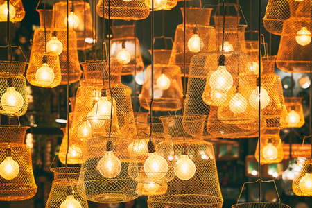 Bright lights of lamps on the ceiling in the restaurant. Lamps in the fishing net. Fashionable design for a beautiful institutionの写真素材