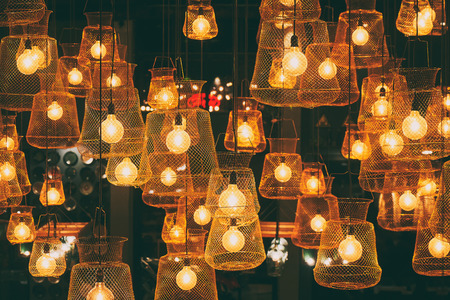 Bright lights of lamps on the ceiling in the restaurant. Lamps in the fishing net. Fashionable design for a beautiful institutionの写真素材