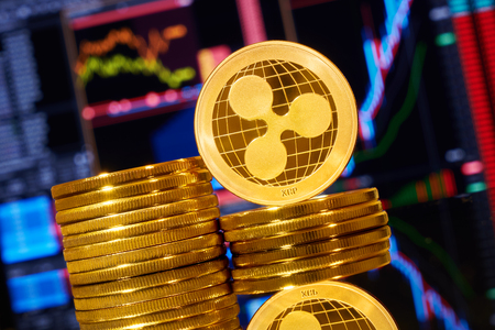 Gold ripple stacked on a bright background of business graphics close-up. Ripple crypto-currency. Anonymous. Virtual currencyの写真素材