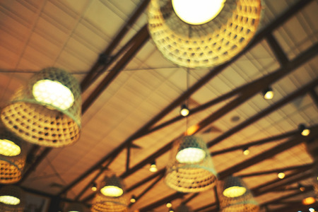 Bright lights of lamps on the ceiling in the restaurant. Lamps in the fishing net. Fashionable design for a beautiful institutionの写真素材
