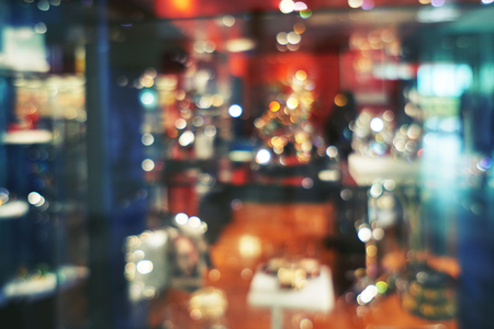 Blurred fashion boutique with jewelry made of precious metals. Big sales Black Friday for Christmas. Store jewelry in silver and gold. Vetrin beautiful jewelry storeの写真素材