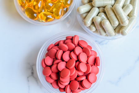 Closeup of  Supplements include herbal neem, iron, and cod liver oil.