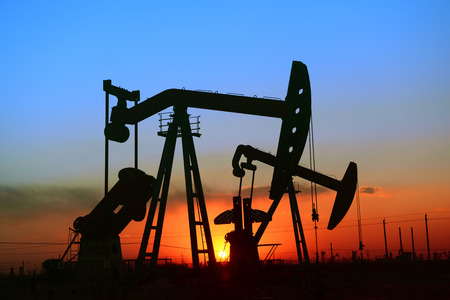 The setting sun is operation of the pumping unit in oil fieldの写真素材