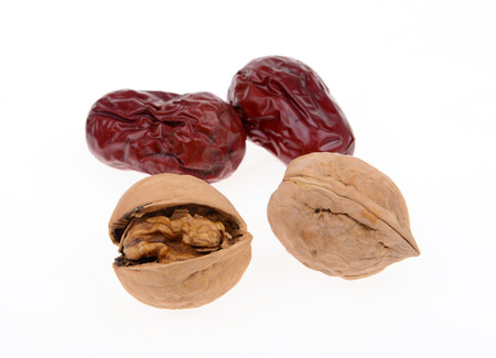 Walnuts and red jujube isolated on a white backgroundの写真素材