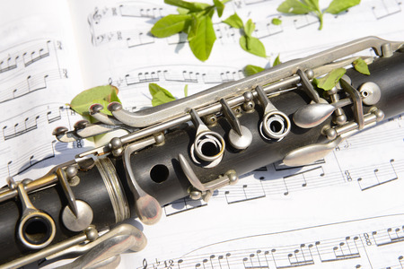 A clarinet close-up on a music noteの写真素材