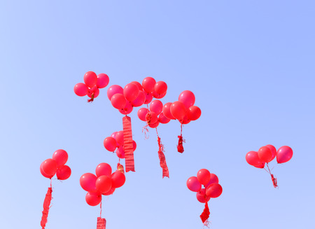 Red balloons in the blue skyの写真素材
