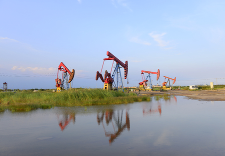 Beam pumping unit in the work, under the blue sky の写真素材