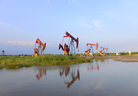 Beam pumping unit in the work, under the blue sky の写真素材