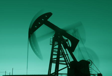 The beam pumping unit is homework, in the fields under the setting sun の写真素材