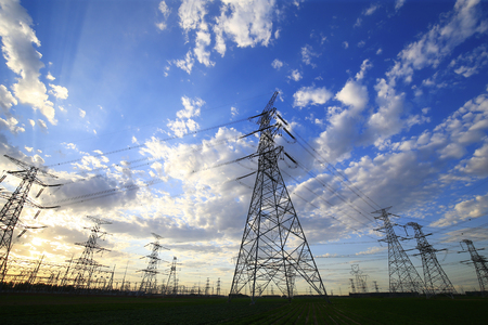 Many electric towers in the sunset sky background