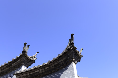 The corner of the ancient building against the blue sky