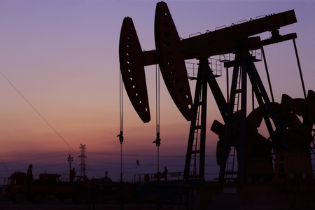 The pumping unit is at work in the evening of the oilfieldの写真素材