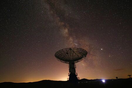 Radio telescopes and the Milky Way at night
