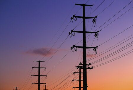 High voltage tower, silhouetted in the eveningの写真素材
