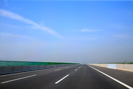 Beautiful highway, under the blue sky and white clouds