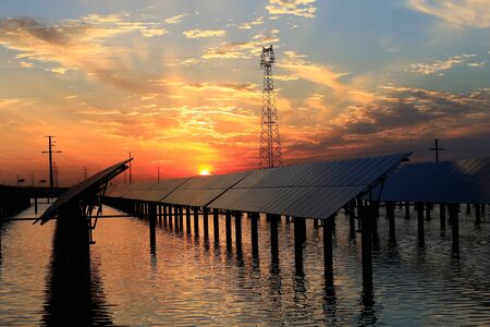 Solar photovoltaic panels in the water, in the sunset sky background