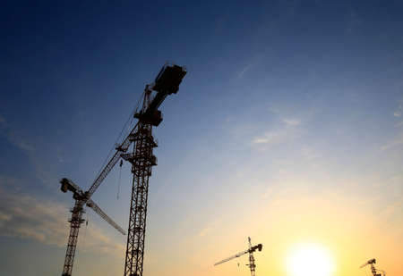 Crane at construction site, silhouette of sunriseのeditorial素材