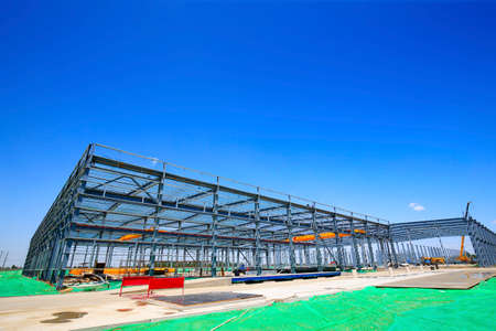 Steel frame structure factory building, in the blue sky and white clouds background