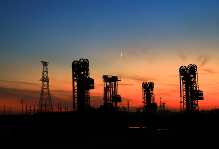A silhouette of a pumping unit working in the eveningの写真素材