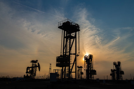 A silhouette of a pumping unit working in the eveningの写真素材