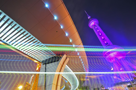 the light trails on the modern building background in shanghai chinaのeditorial素材