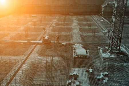 worker in the construction site making reinforcement metal framework for concrete pouringの写真素材