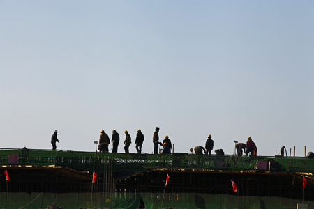 Reinforced concrete structure, the workers in the construction site in silhouetteのeditorial素材