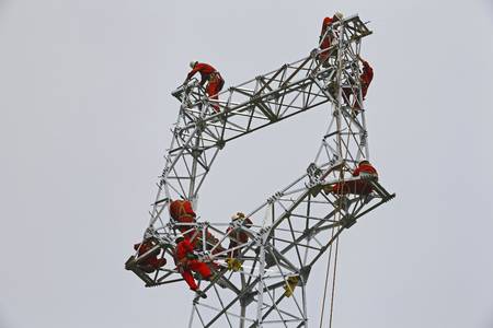 The workers on the pylon