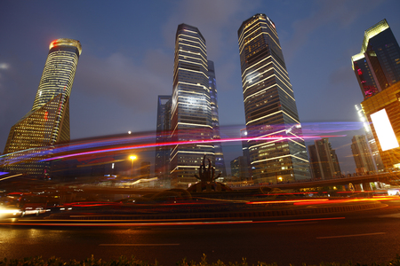 the light trails on the modern building background in shanghai chinaのeditorial素材