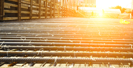 worker in the construction site making reinforcement metal framework for concrete pouring