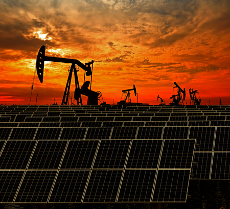 Oil pump with solar panels during sunsetの写真素材