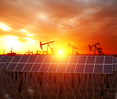 Clean power energy concept,Oil pump with solar panels and the sunsetのeditorial素材