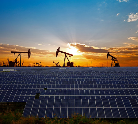 Clean power energy concept,Oil pump with solar panels and the sunsetのeditorial素材