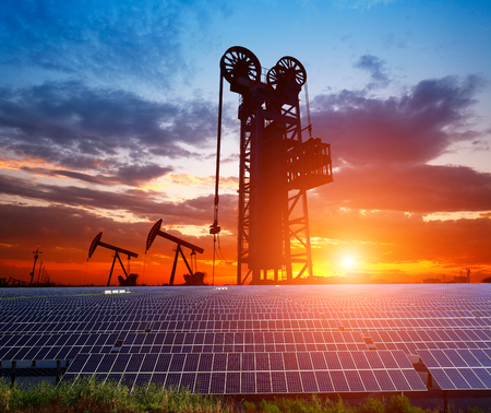 Clean power energy concept,Oil pump with solar panels and the sunsetの写真素材