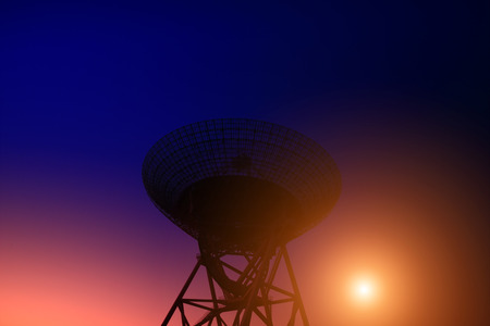 The silhouette of a radio telescope observatory