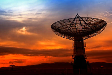 The silhouette of a radio telescope observatoryの写真素材