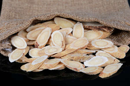 Chinese herbal medicine astragalus membranaceus on a white background, close-up picturesの写真素材
